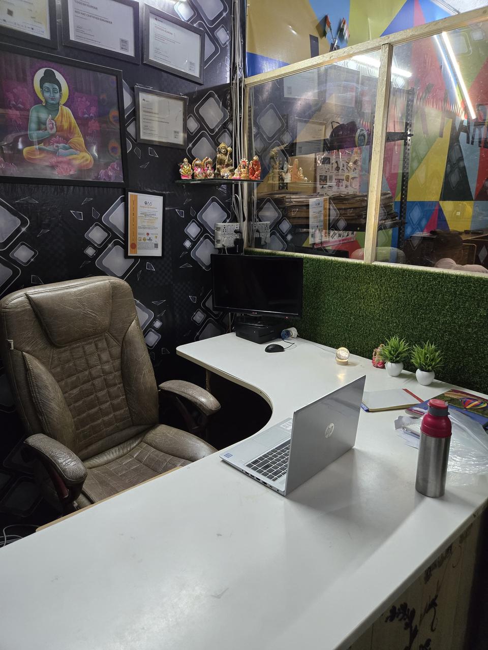 Director's cabin at VidyaTech with framed certificates on the wall and a work desk