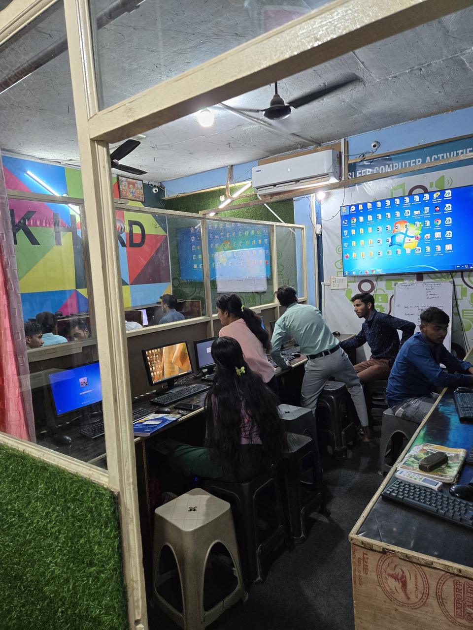 Students working on desktop computers in VidyaTech's air-conditioned computer lab